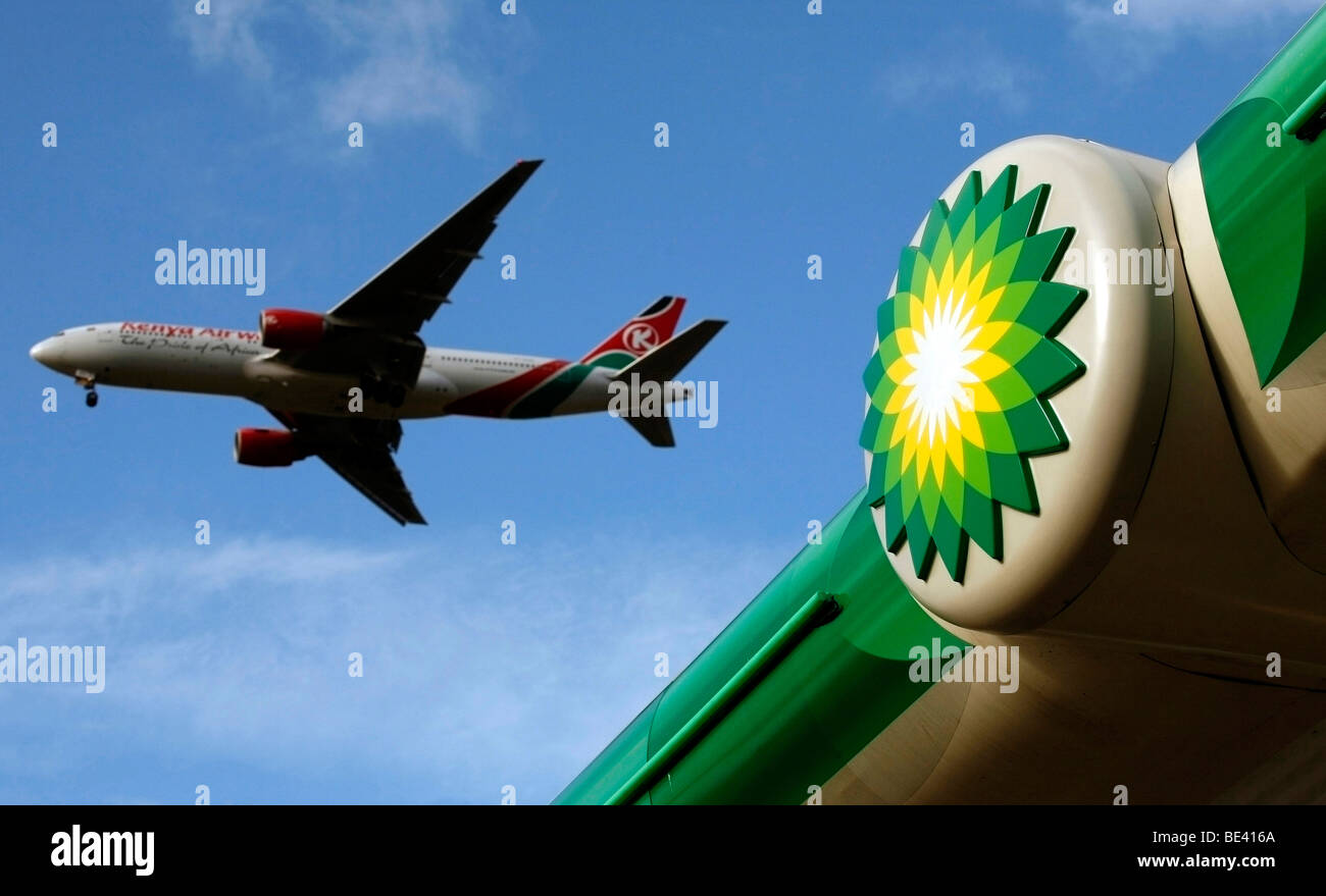 kenya air ways aeoplane flys past a Shell Petrol station as it leaves heathrow airport in west london Stock Photo