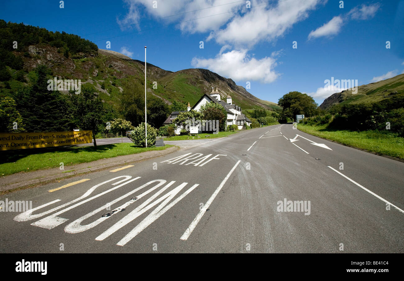 a welsh pub hotel on a slow araf road with Cadar idris mountain range in the distance Stock Photo