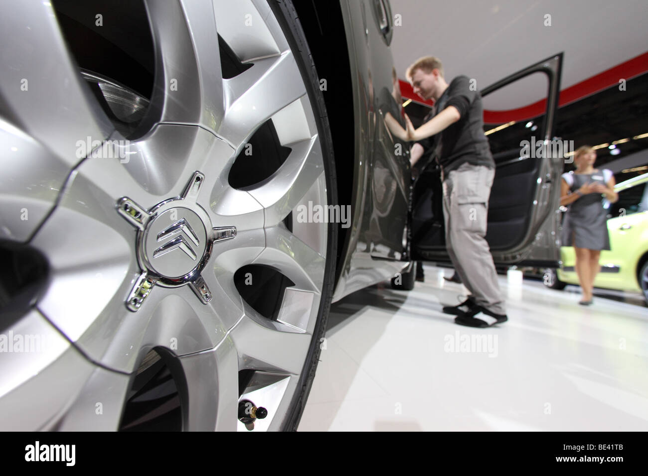 63th International Motor Show ( IAA ): A visitor is interested in a car of the manufacturer Citroen Stock Photo