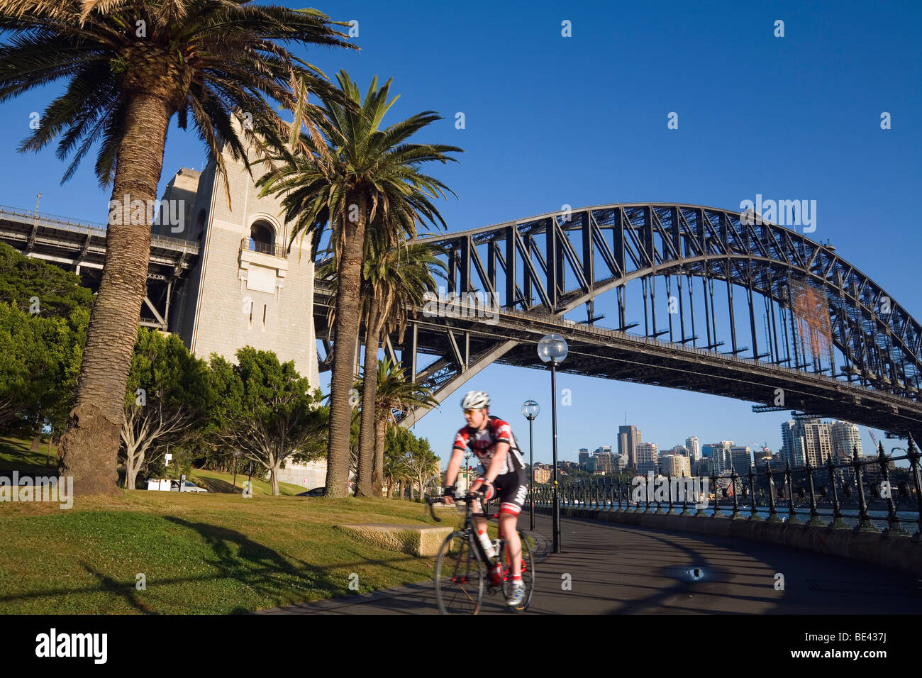Morning cyclist at Dawes Point Reserve, below the Sydney Harbour Bridge. The Rocks, Sydney, New South Wales, AUSTRALIA Stock Photo