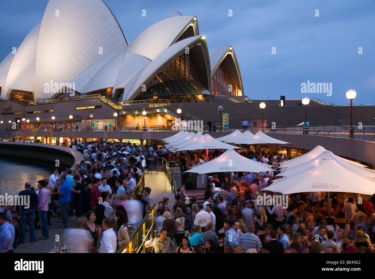 Crowds fill the Opera Bar on the Sydney harbour waterfront. Circular Quay, Sydney, New South