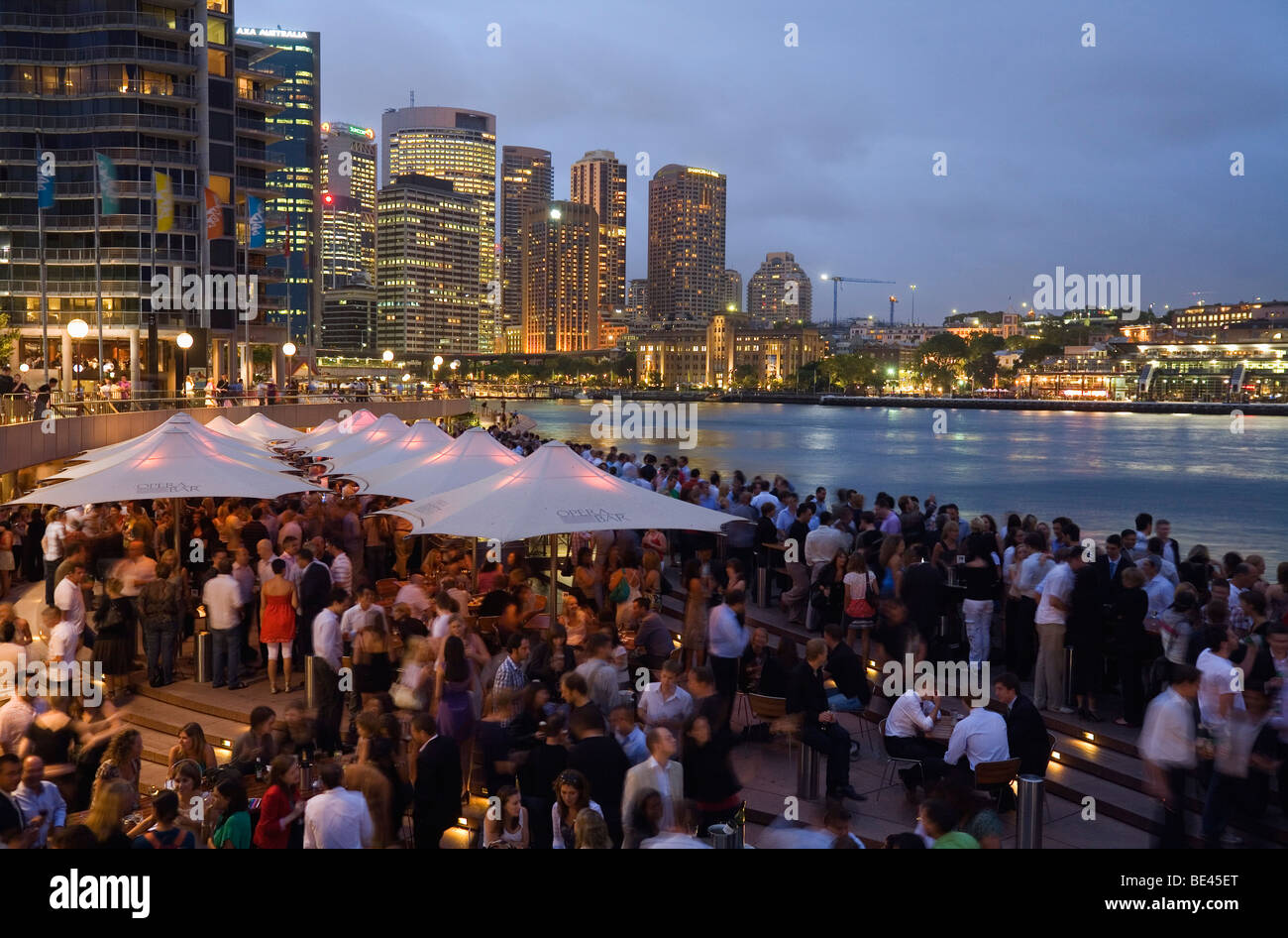 Crowds fill the Opera Bar on the Sydney waterfront with Circular Quay in the background.  Sydney, New South Wales, AUSTRALIA Stock Photo