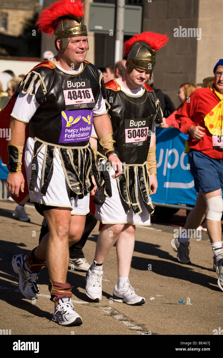 Men wearing Roman soldier style fancy dress costumes participate in the the 2009 Bupa Great North Run. Stock Photo