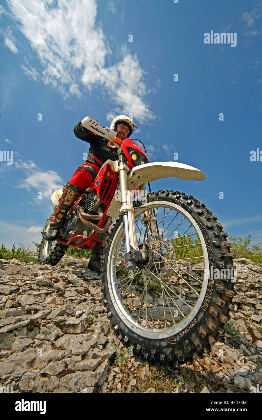 Off-road motorcyclist on rocks in the south of France, France, Europe Stock Photo