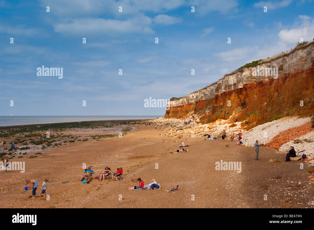 The beach and cliffs with people at Hunstanton , North Norfolk , Uk Stock Photo