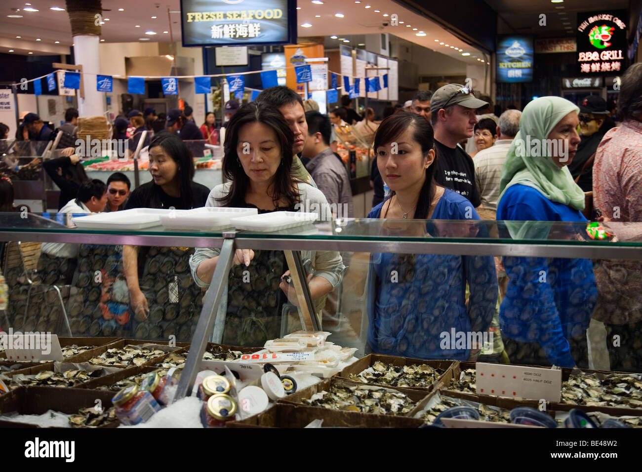 Customers buying fresh seafood at the Sydney Fish Market. Blackwattle