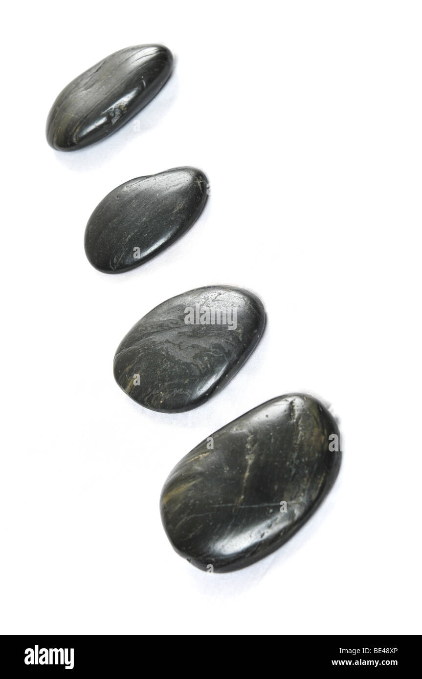 black pebbles with focus on the center isolated against a white background Stock Photo