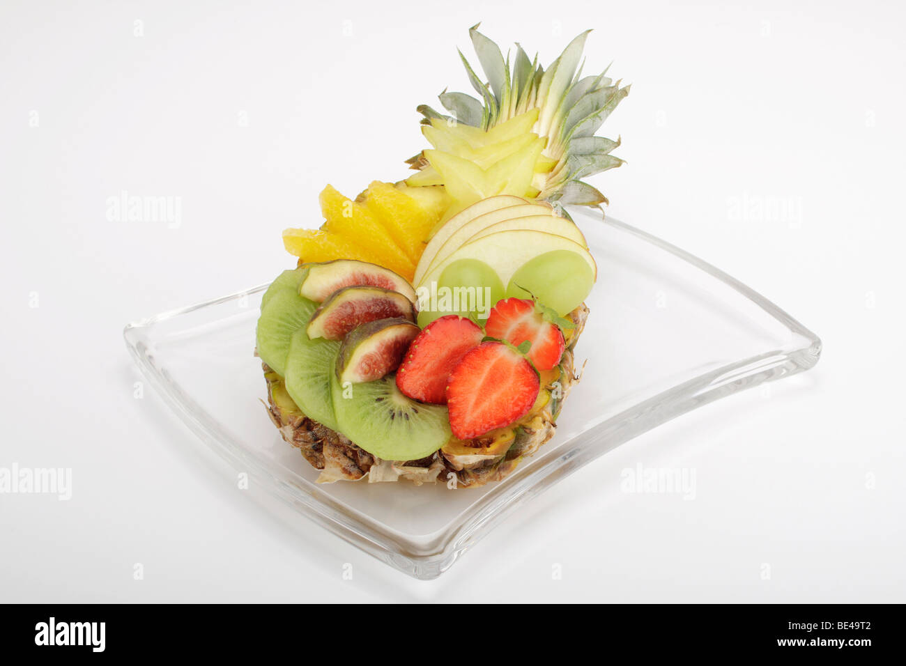 Colourful fruit salad in a baby pineapple Stock Photo