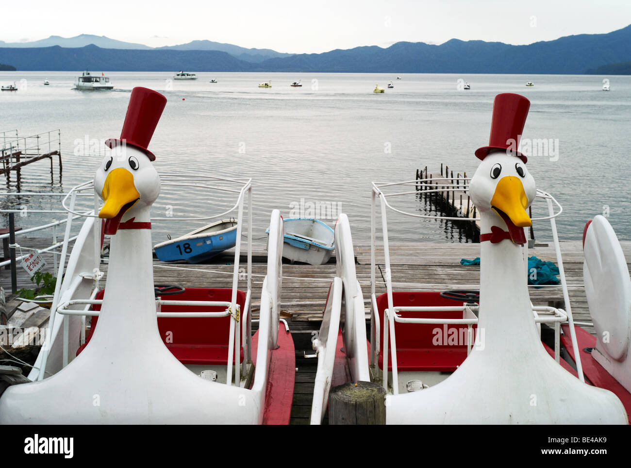 Swan boats at the marina of Lake Shikotsu. Stock Photo