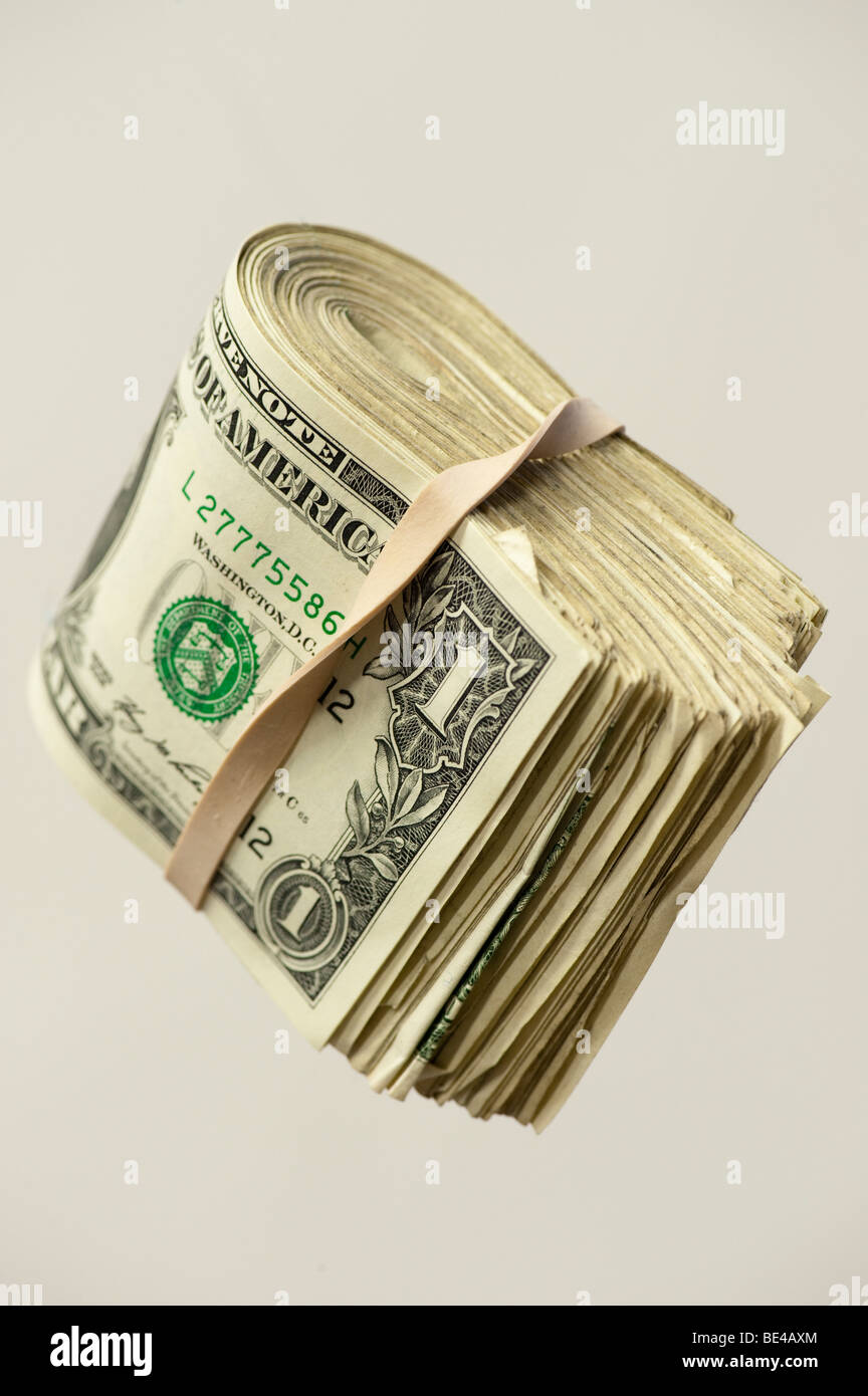 one dollar bills folded in rubber band Stock Photo