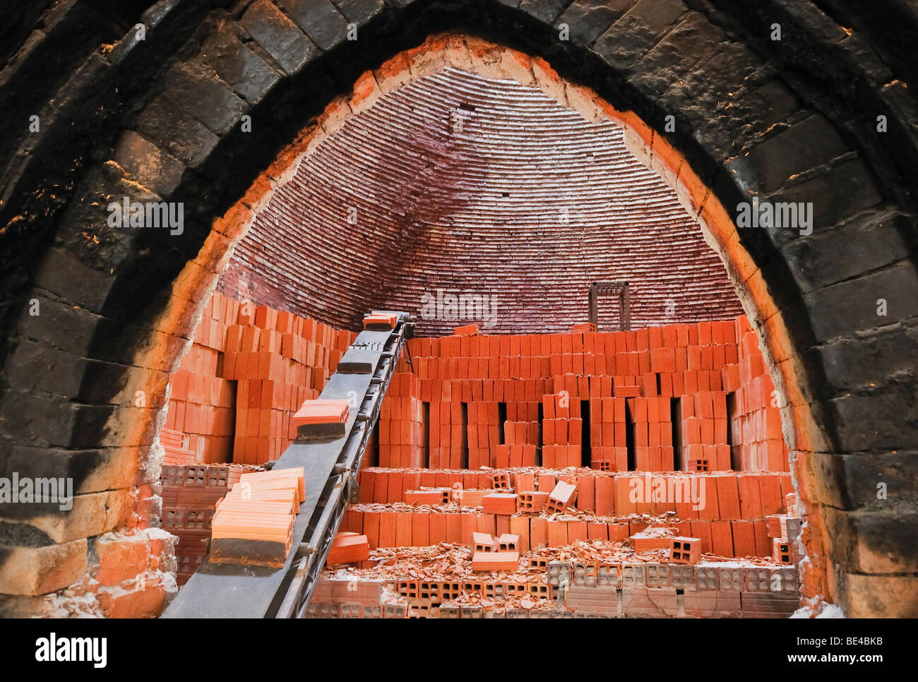 Conveyor belt with bricks in a kiln, Vinh Long, Mekong Delta, Vietnam, Asia Stock Photo