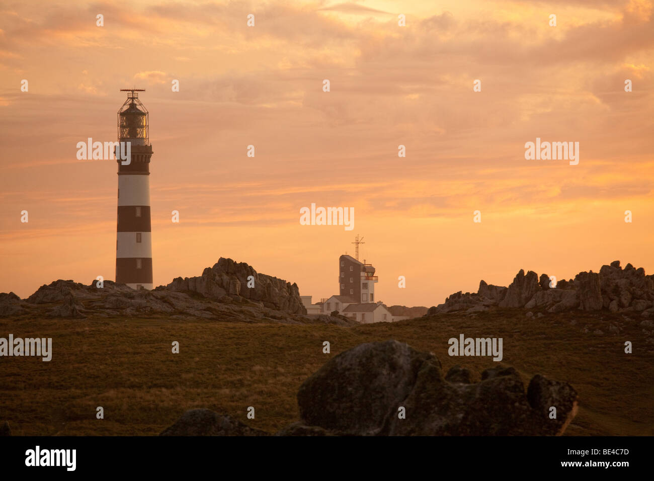 ouessant island rocky coastline at dusk with creac'h lighthouse, brittany, finistere, france Stock Photo