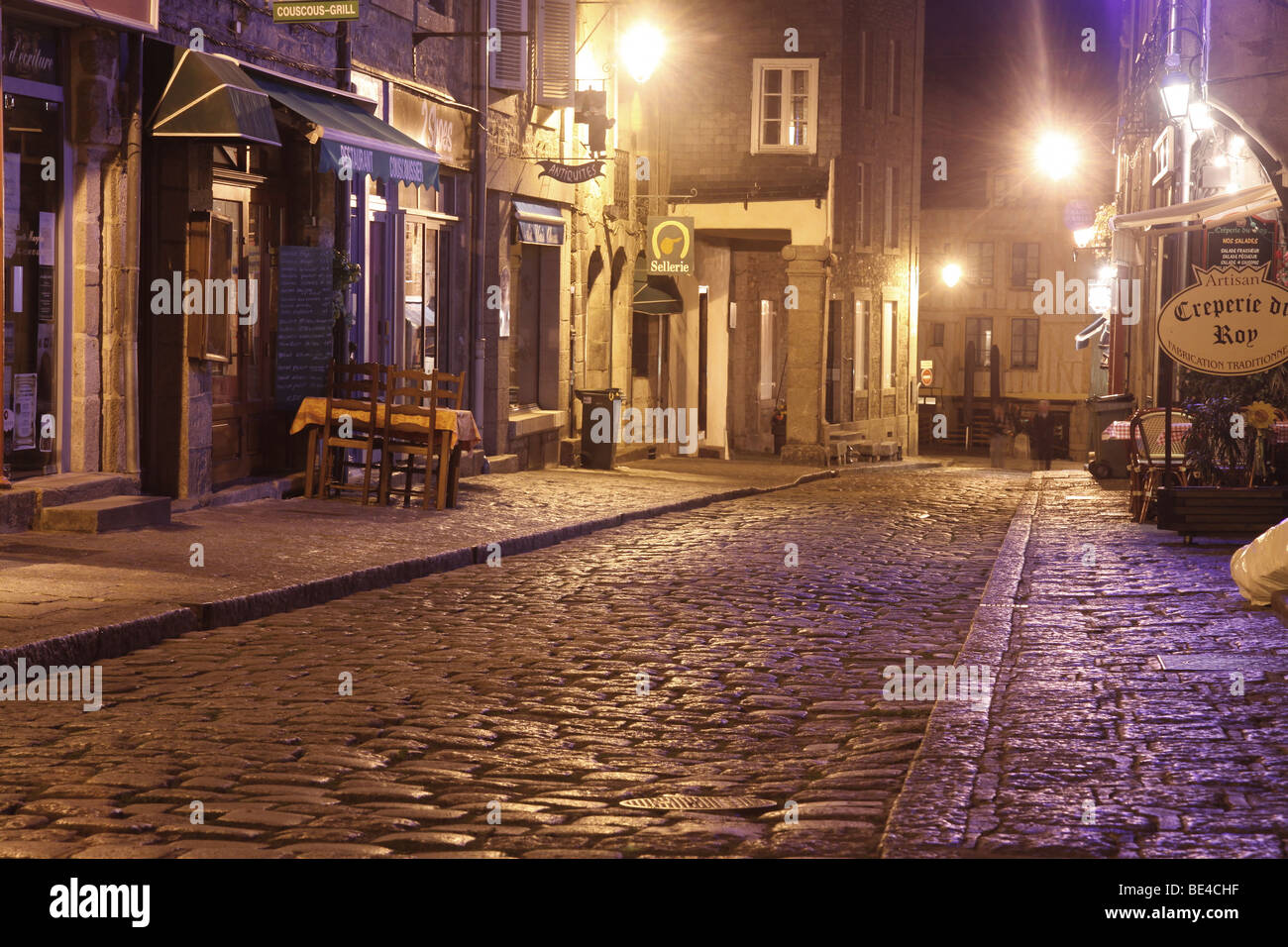 Solitary cobbled stone streets by night of old Dinan, France Stock Photo