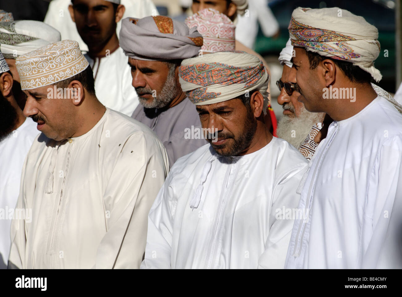 Omani men in traditional dress, livestock or animal market at Nizwa ...