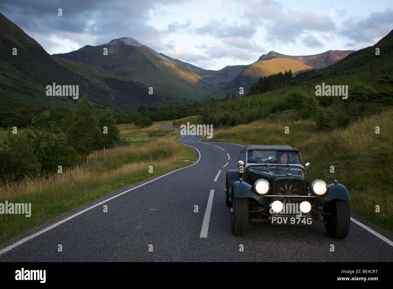 Winding mountain road with classic car, Glen Nevis, Scotland Stock Photo