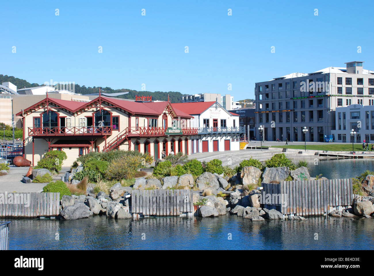 Historic Boat House with New Zealand stock exchange, the NZX Centre in background, situated on Wellington's waterfront. Stock Photo