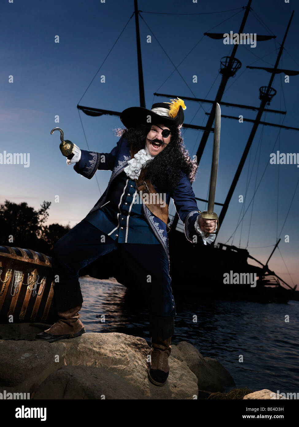 Pirate ashore with a treasure chest Stock Photo