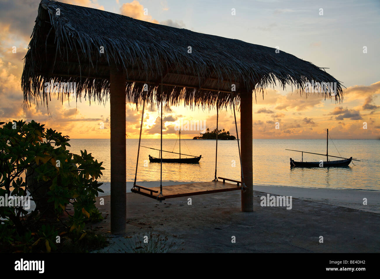 Silhouette, swing with roof, beach, bush, boats, sunset, Maldive island, South Male Atoll, Maldives, Achipelago, Asia, Indian O Stock Photo
