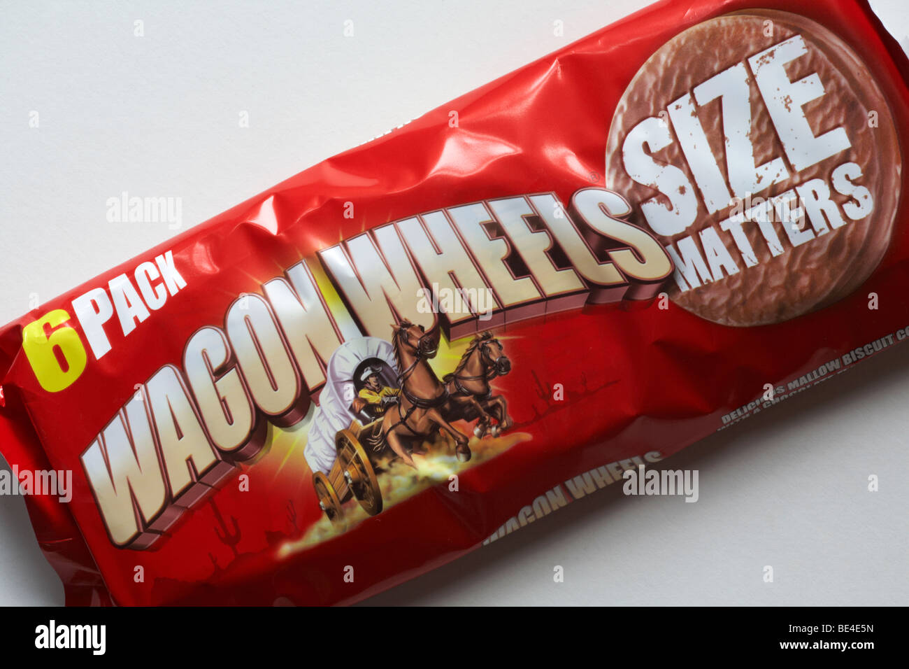 6 pack of original Wagon Wheels biscuits set on white background - delicious mallow biscuit covered with a chocolate flavoured coating Stock Photo