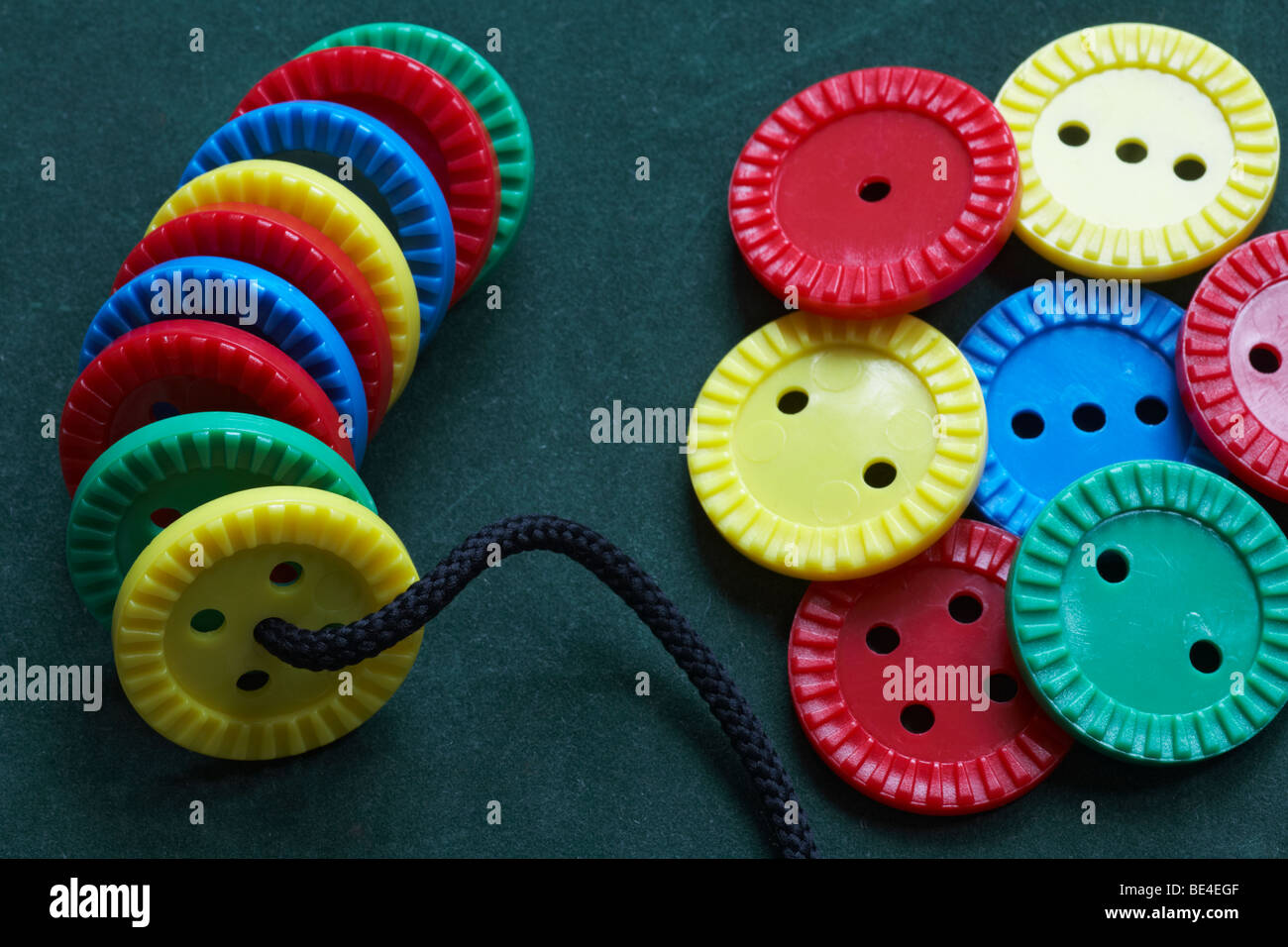 learning to thread buttons Stock Photo Alamy
