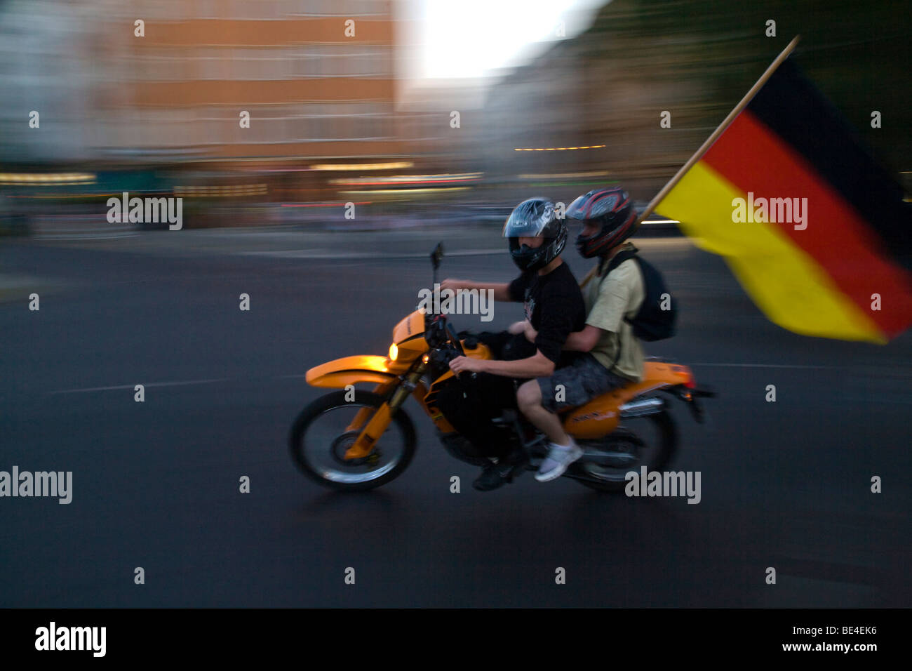 Motorcyclists riding with a German flag, Berlin, Germany, Europe Stock Photo