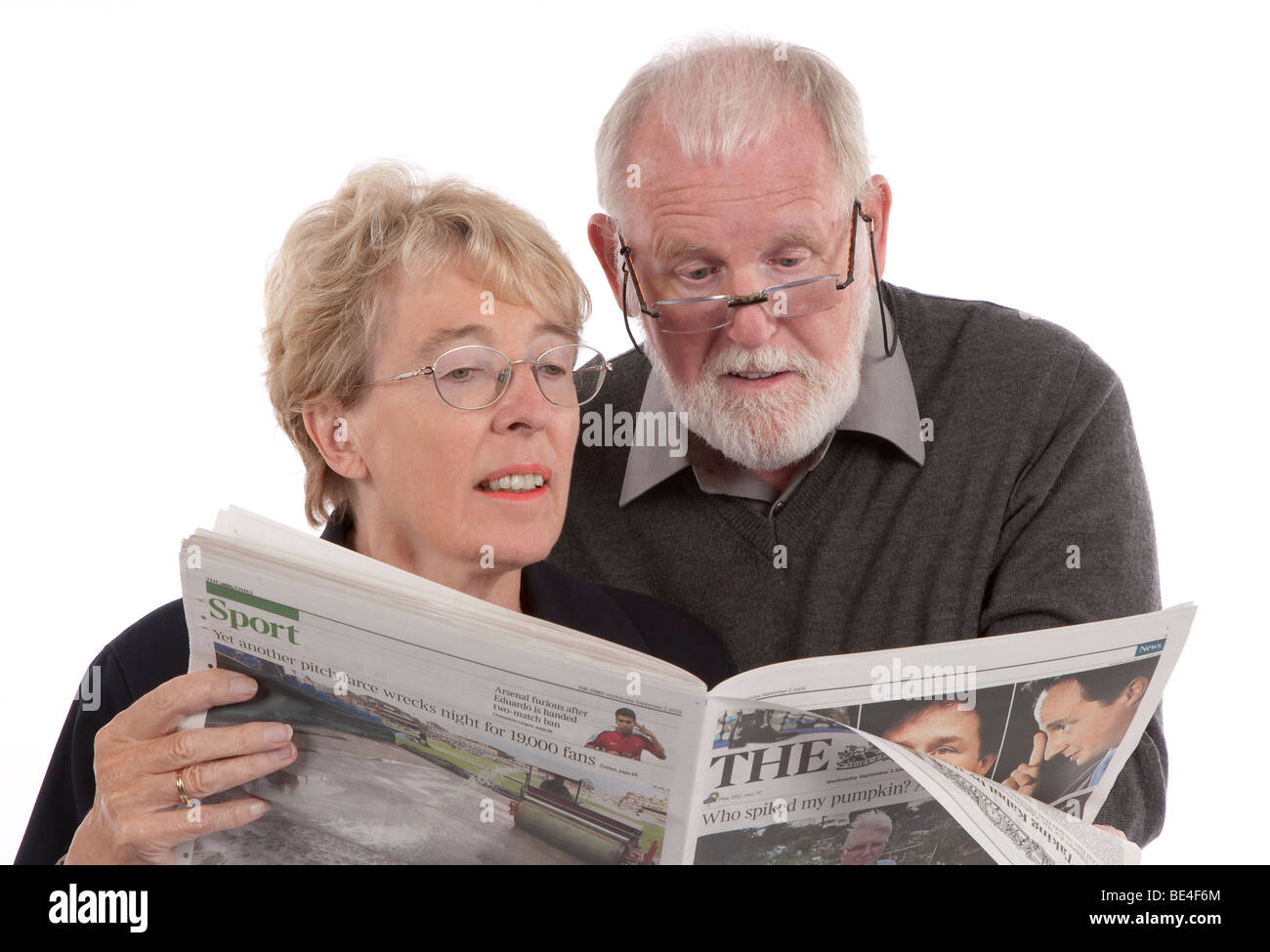 Older retired couple reading newspaper together Stock Photo