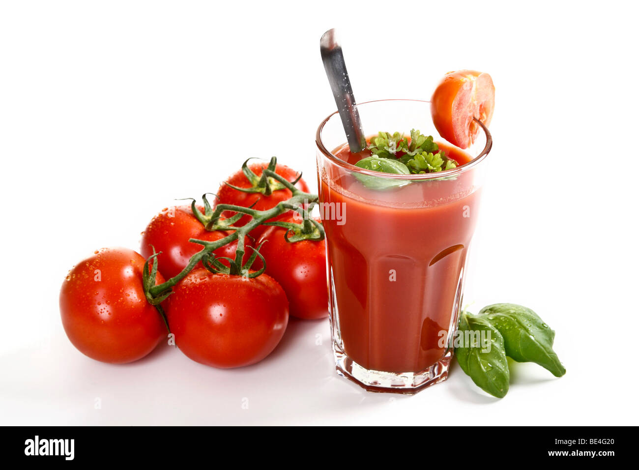 Tomato juice with basil, parsley and beefsteak tomatoes Stock Photo
