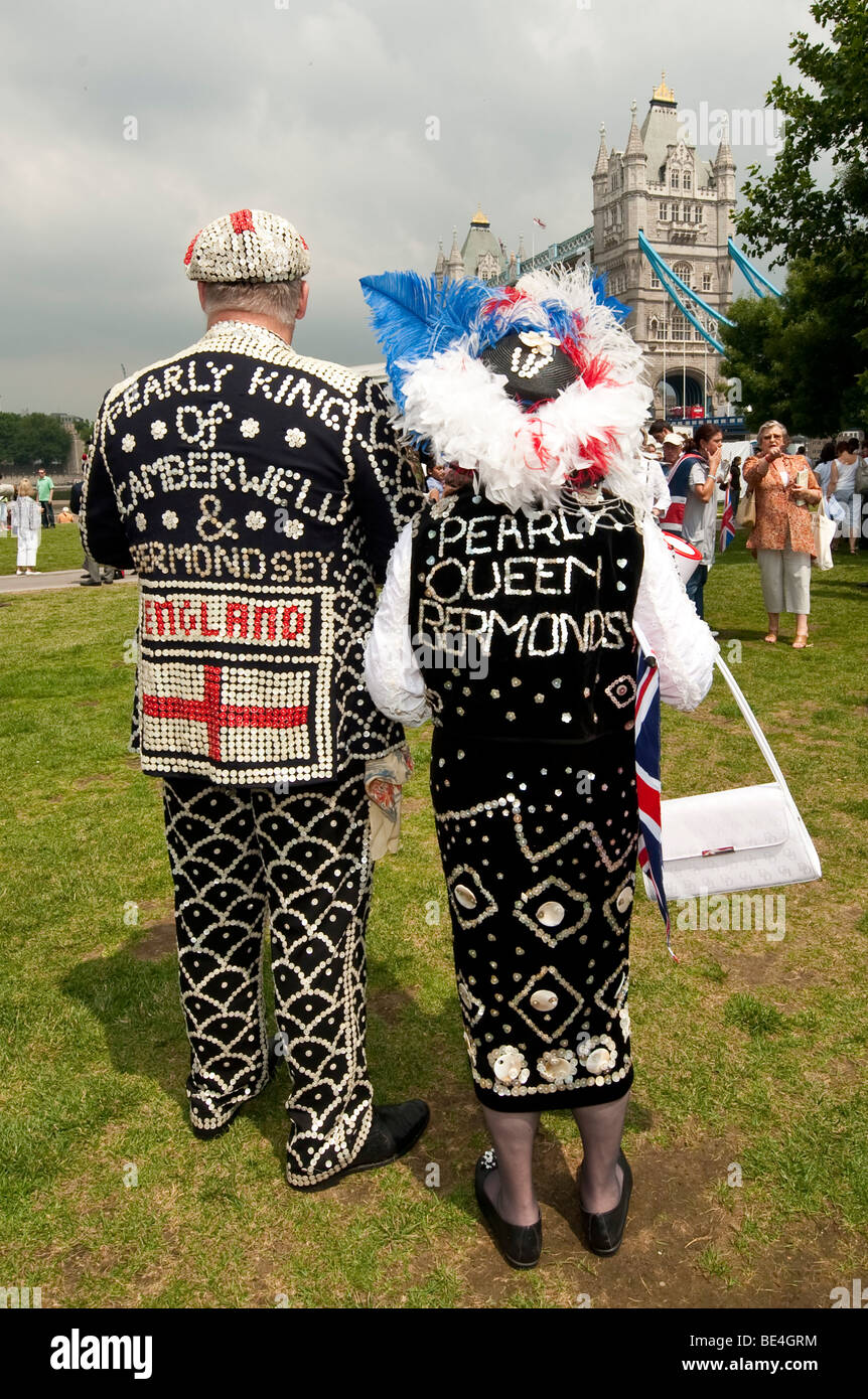Man and woman dressed in traditional Pearly King and Queen costumes covered in mother-of-pearl buttons Stock Photo