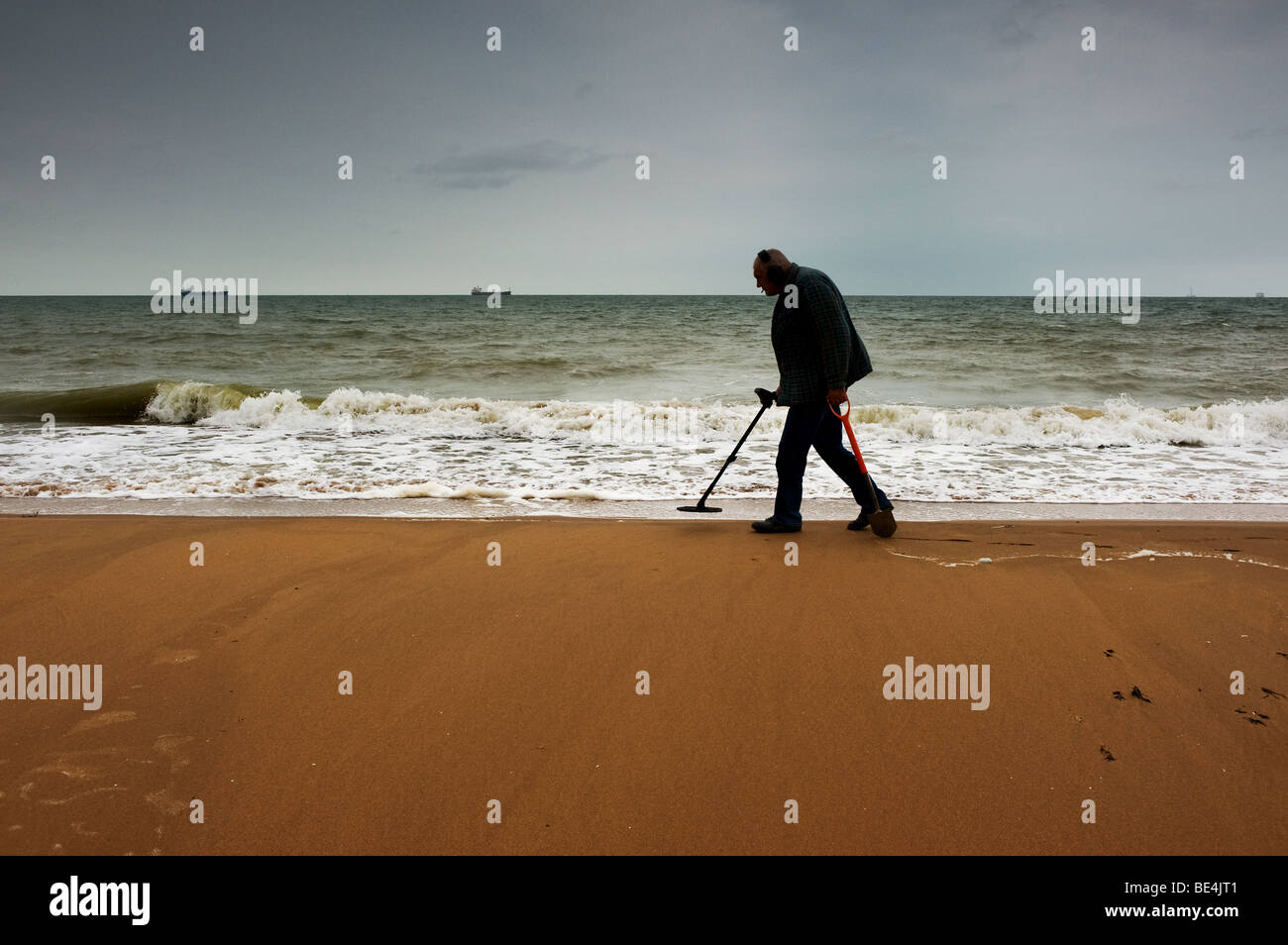 A metal detectorist searching on the beach at Botany bay in Kent. Photo