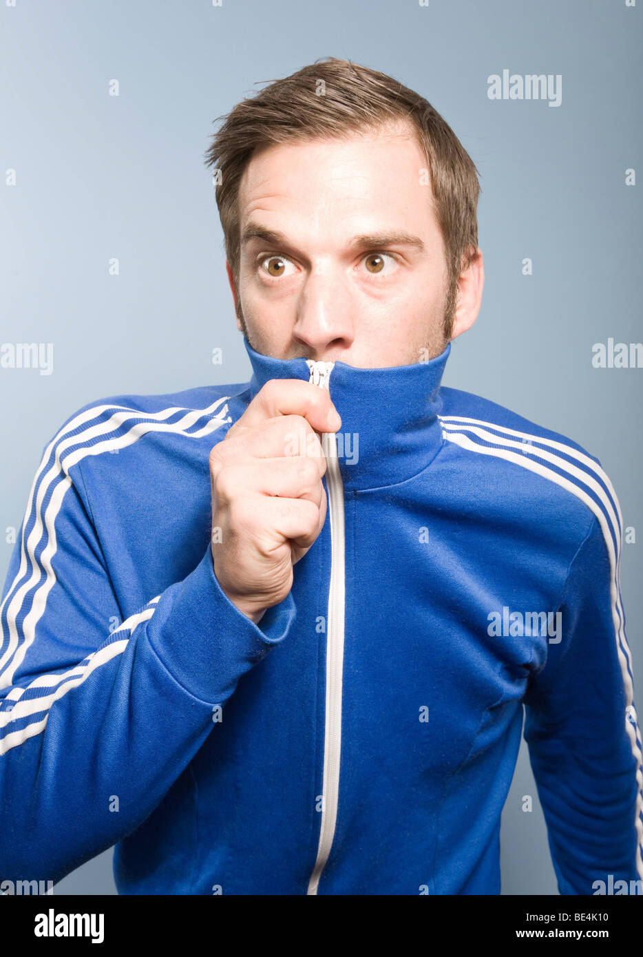 Young man posing in a retro style Adidas sport suit, camouflage Stock Photo