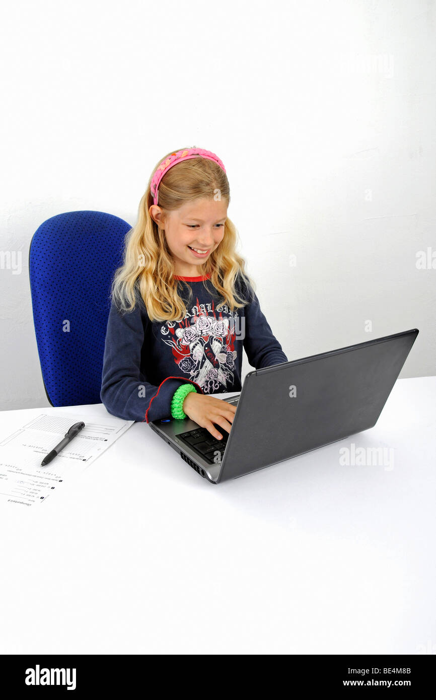 Young schoolgirl enjoys working with a laptop Stock Photo - Alamy