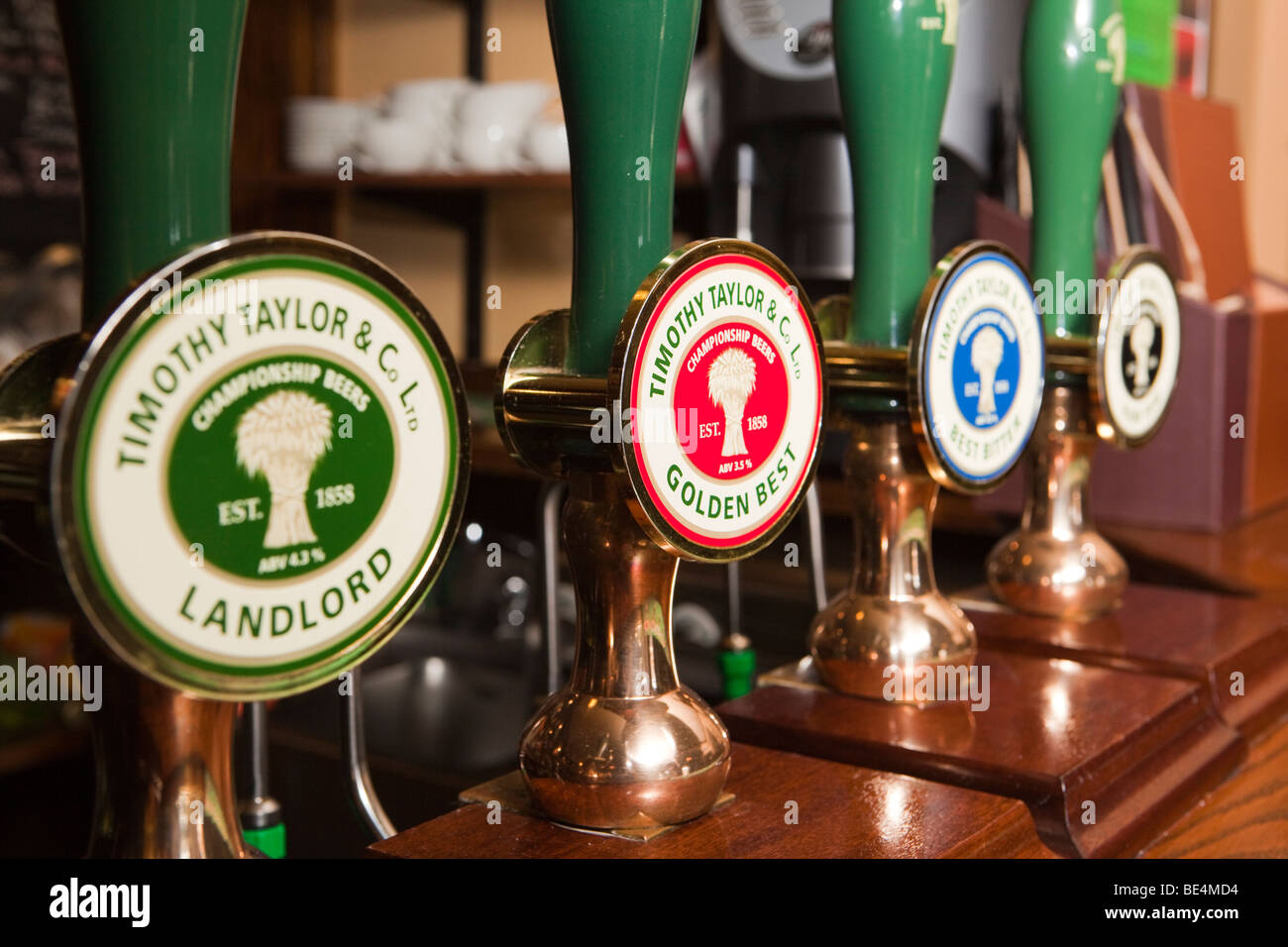 UK, England, Yorkshire, Haworth, Timothy Taylor’s Keighley Brewery beer hand pumps on bar Stock Photo