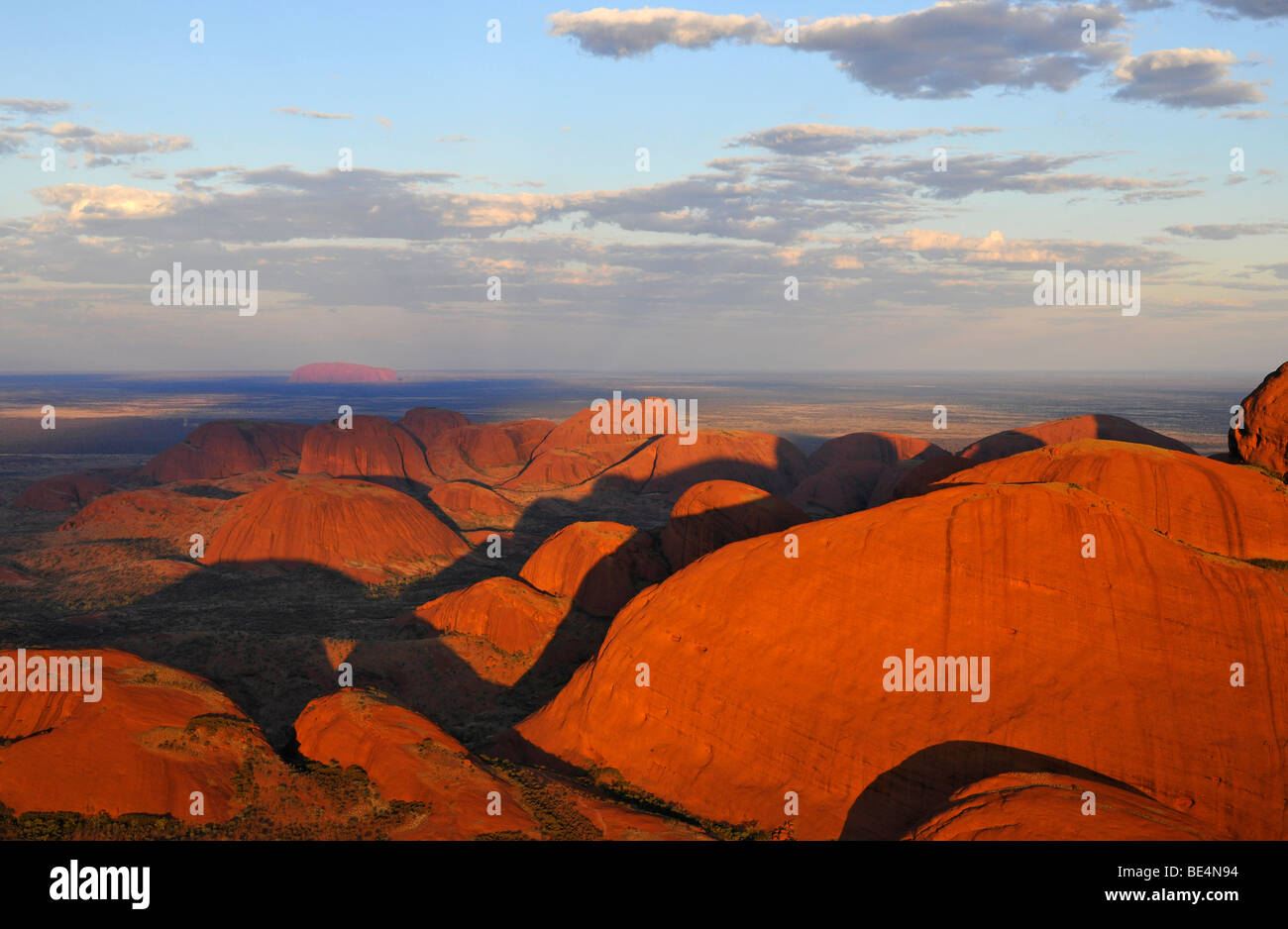 Aerial view of Kata Tjuta, The Olgas in front of Uluru, Ayers Rock at sunset, Uluru-Kata Tjuta National Park, Northern Territor Stock Photo