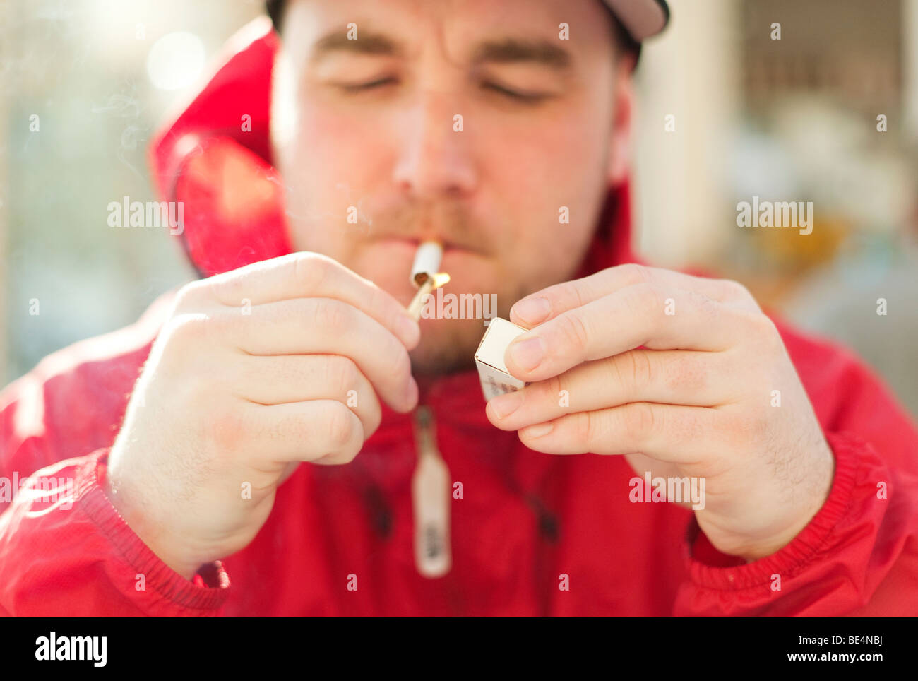 Man lighting up a cigarette Stock Photo Alamy