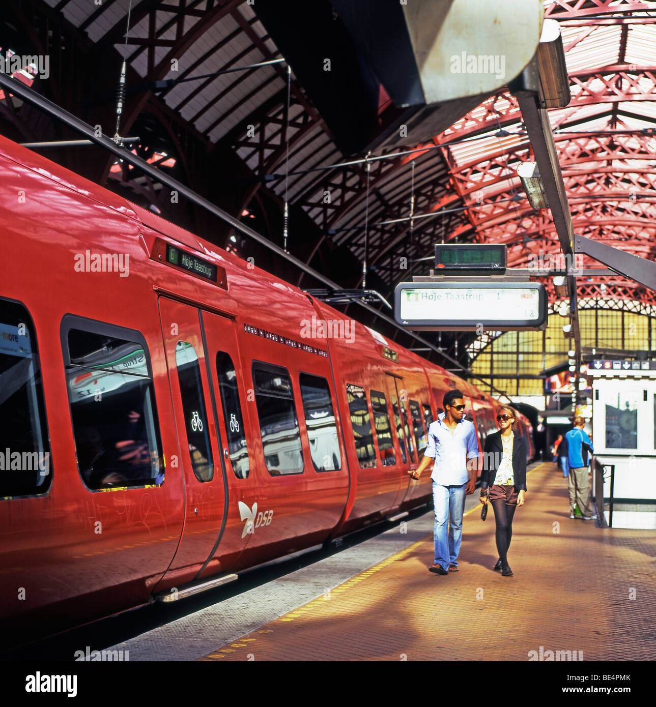 Two people walking along the platform at Central Station, Kobenhavn H, Hovedbanegarden, Copenhagen Denmark  KATHY DEWITT Stock Photo