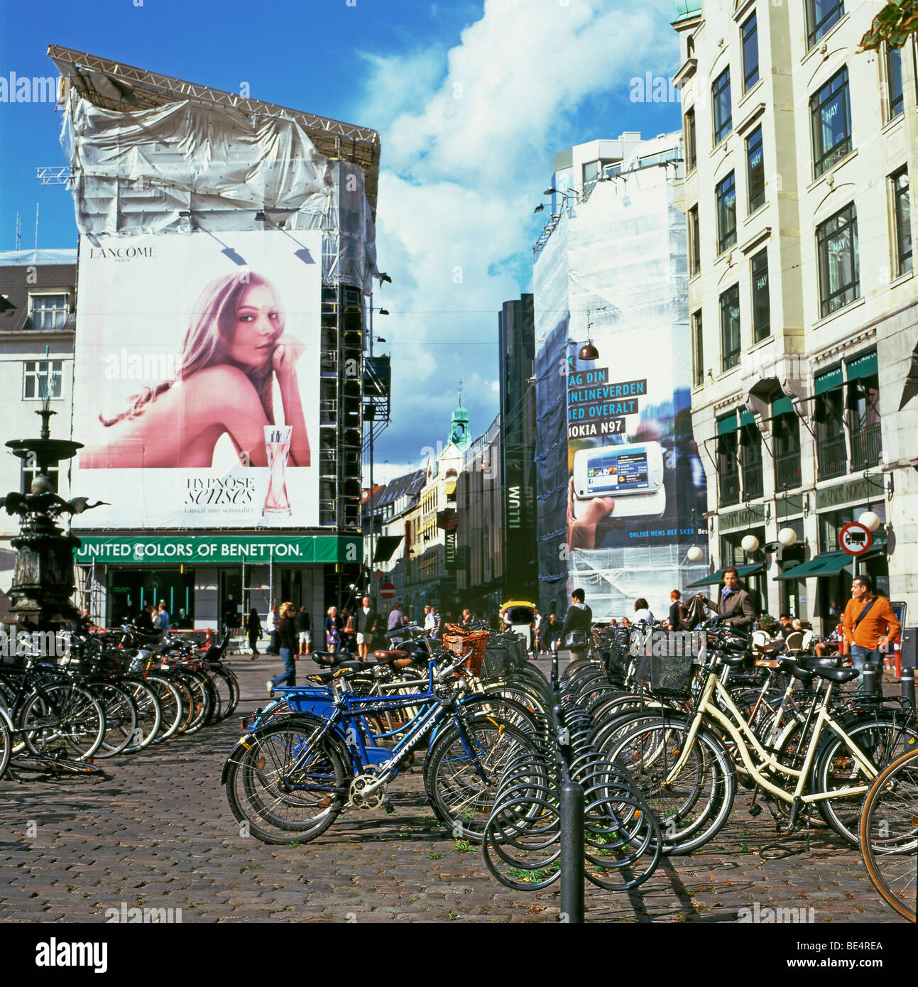 Bikes parked bike rack on cobbled street naked nude seductive woman in  Lancome on sexual billboard poster in Copenhagen Denmark Europe EU KATHY  DEWITT Stock Photo - Alamy