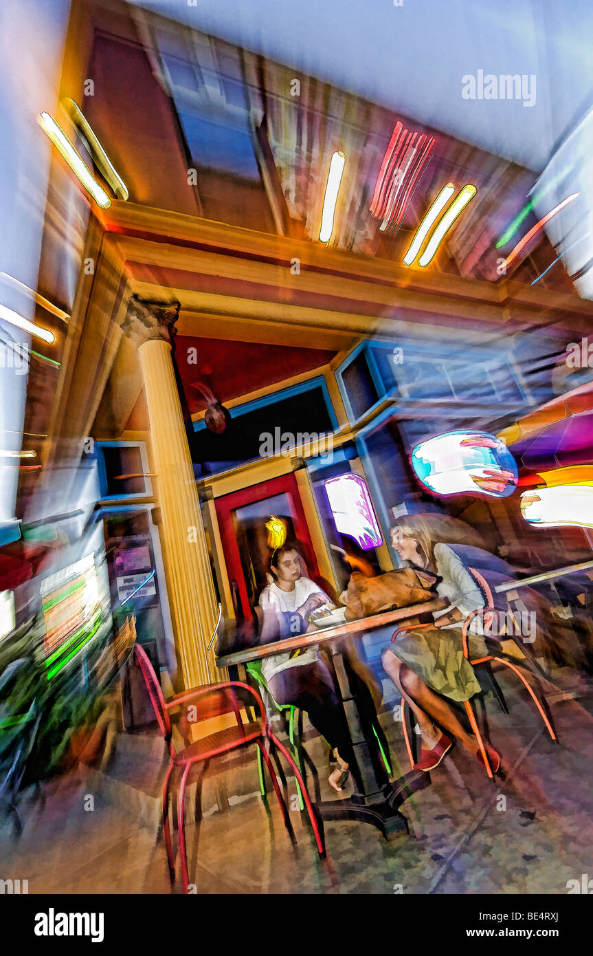Painting Effect of Two Young Women Sitting at Table Outside Cafe 360 on Bardstown Road in Louisville, Kentucky Stock Photo