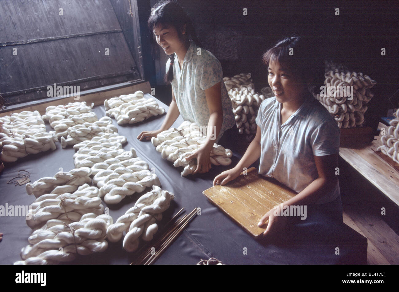 Women working in a silk factory in Beijing during the Cultural Revolution when the city was called Peking Stock Photo