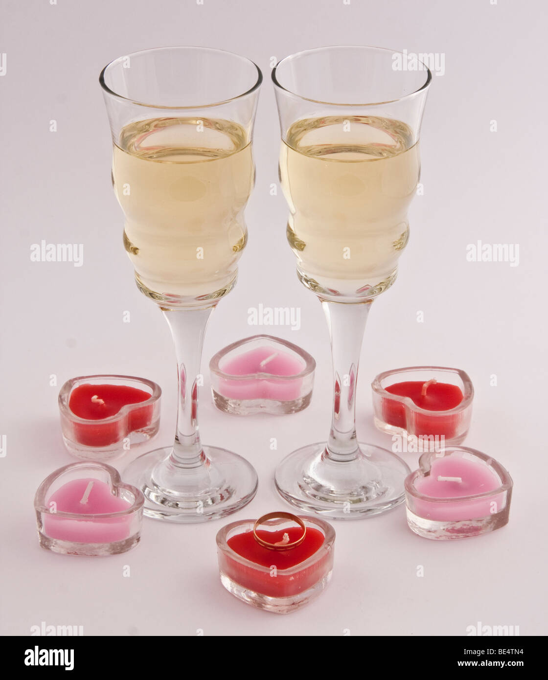 two champagne cups with love candels around Stock Photo