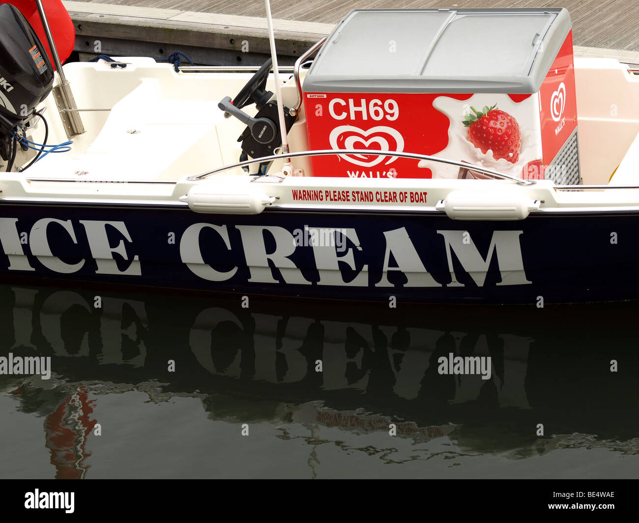 The icecream boat and reflection,in Poole Harbour,Dorset Stock Photo