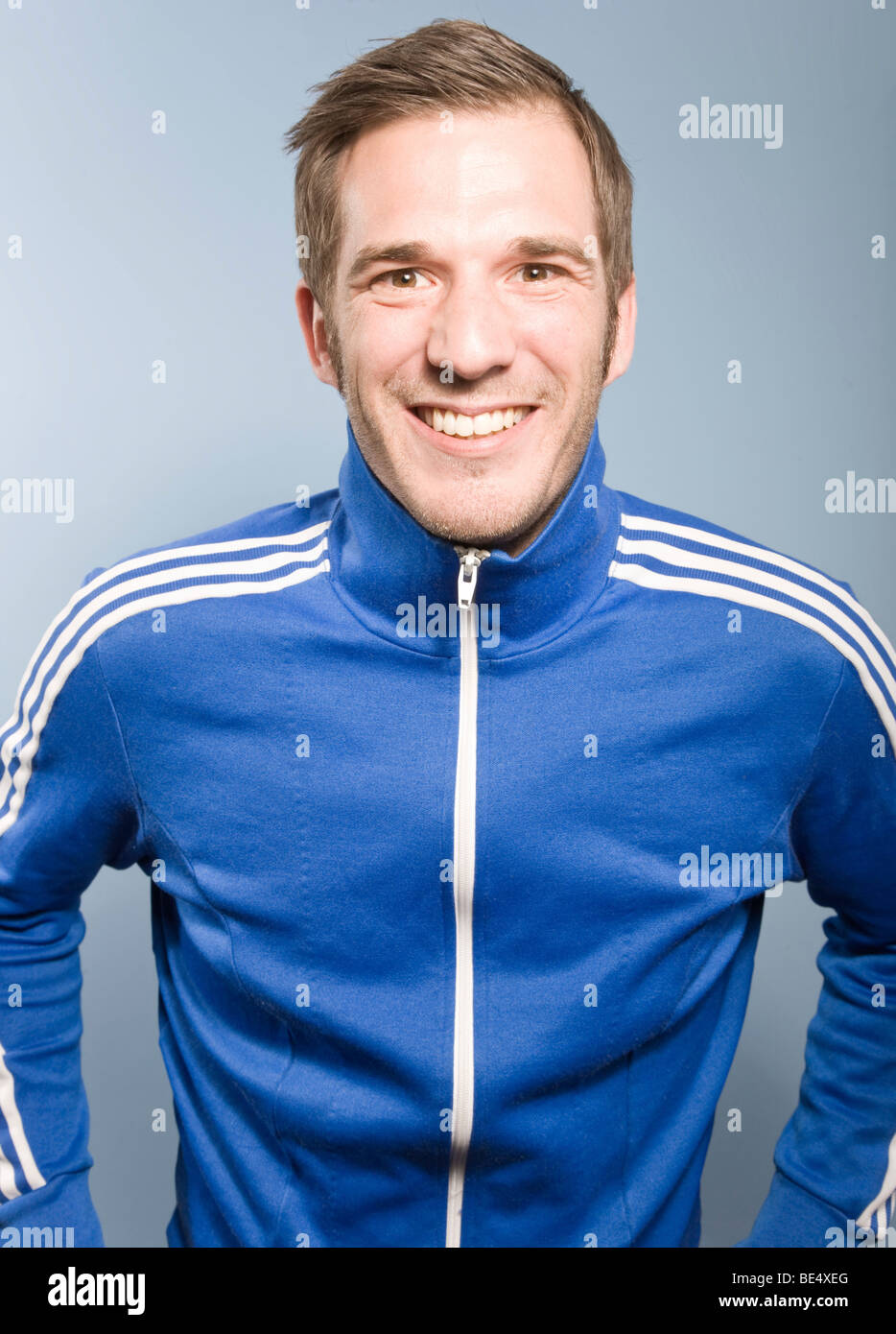 Young man smiling while posing in a retro style Adidas sport suit Stock  Photo - Alamy