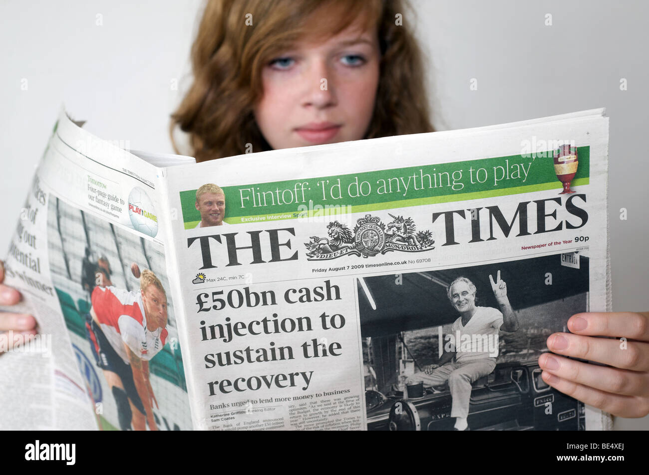 Teenager reading The Times newspaper. Stock Photo