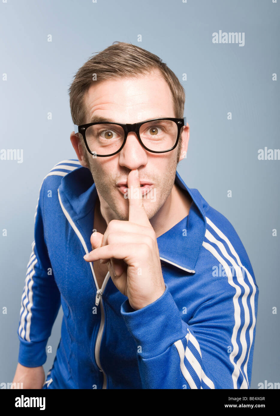 Young man posing in a retro style Adidas sport suit Stock Photo