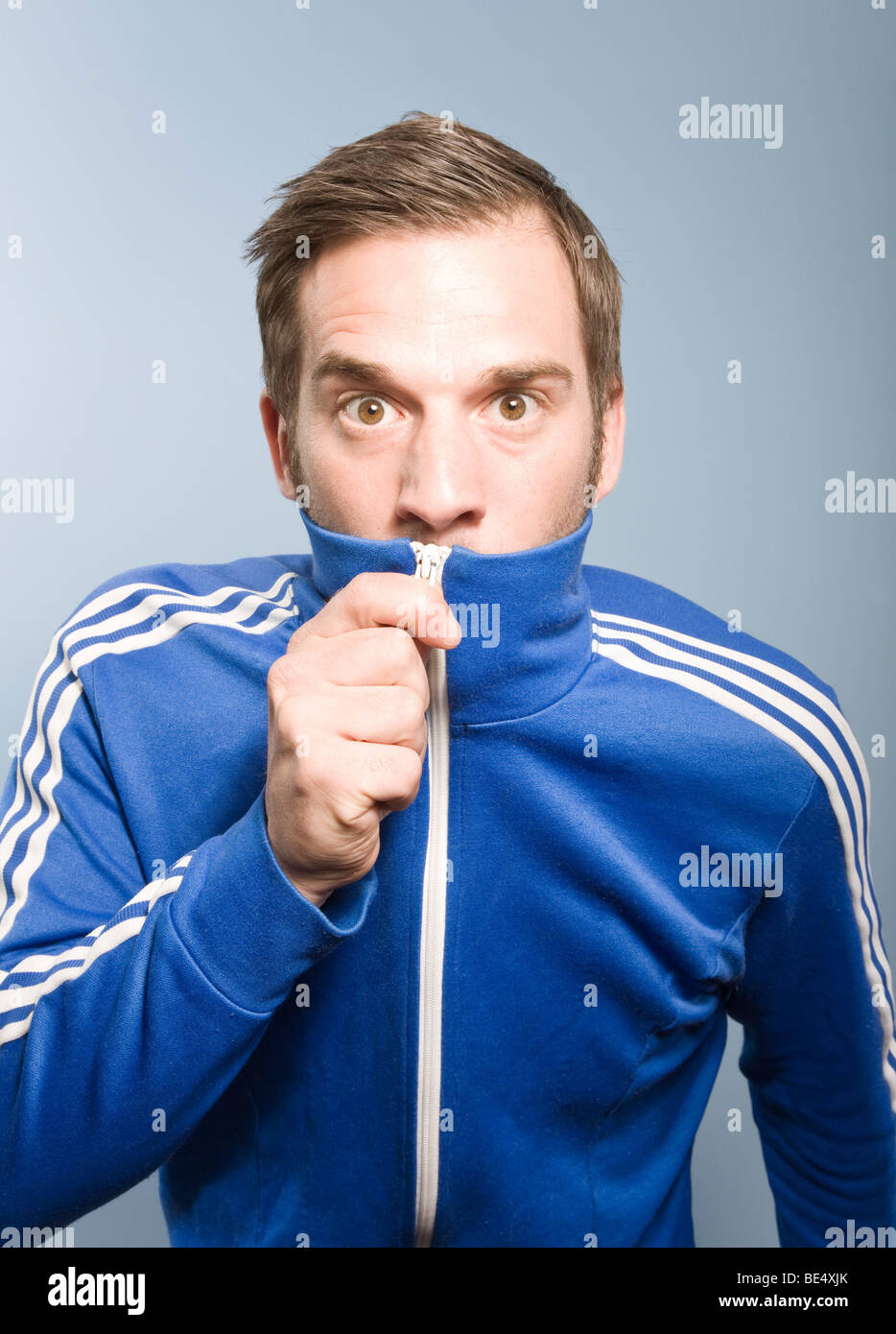 Young man posing in a retro style Adidas sport suit, camouflage Stock Photo