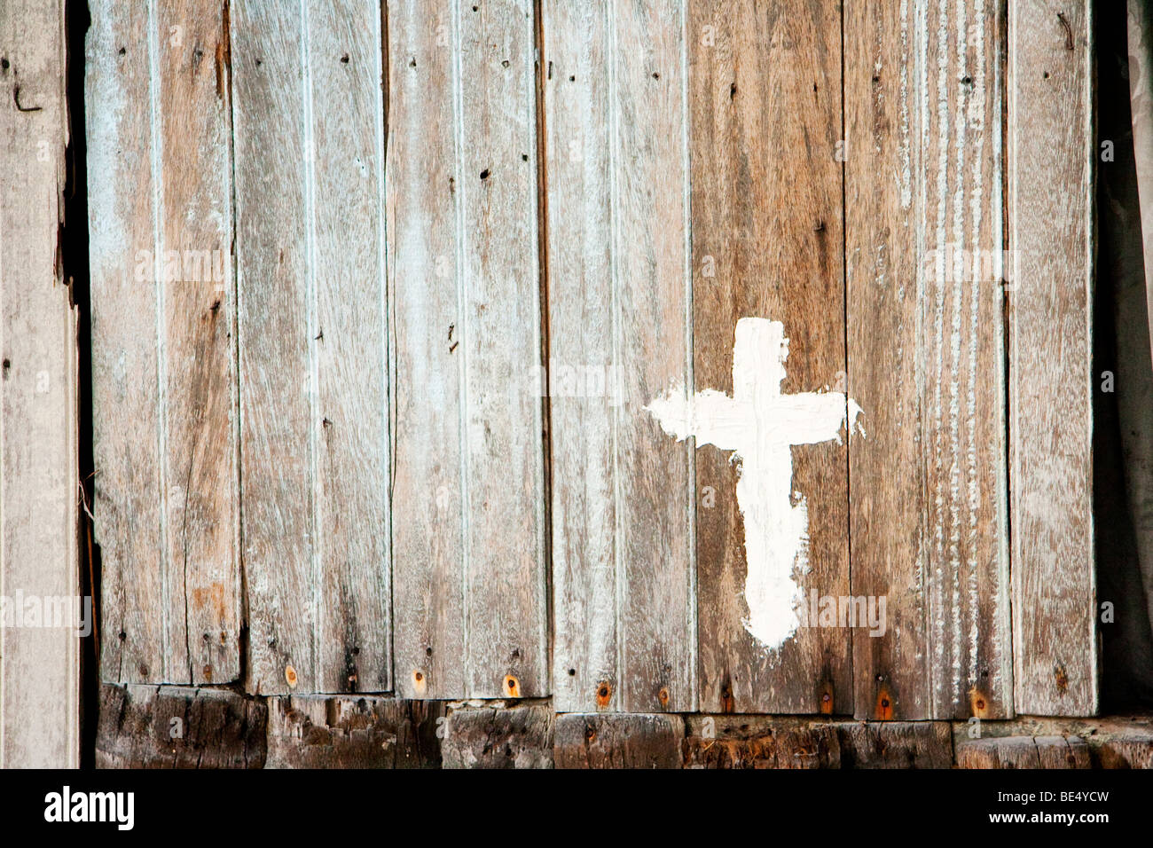 A cross sign on a wooden wall Stock Photo - Alamy