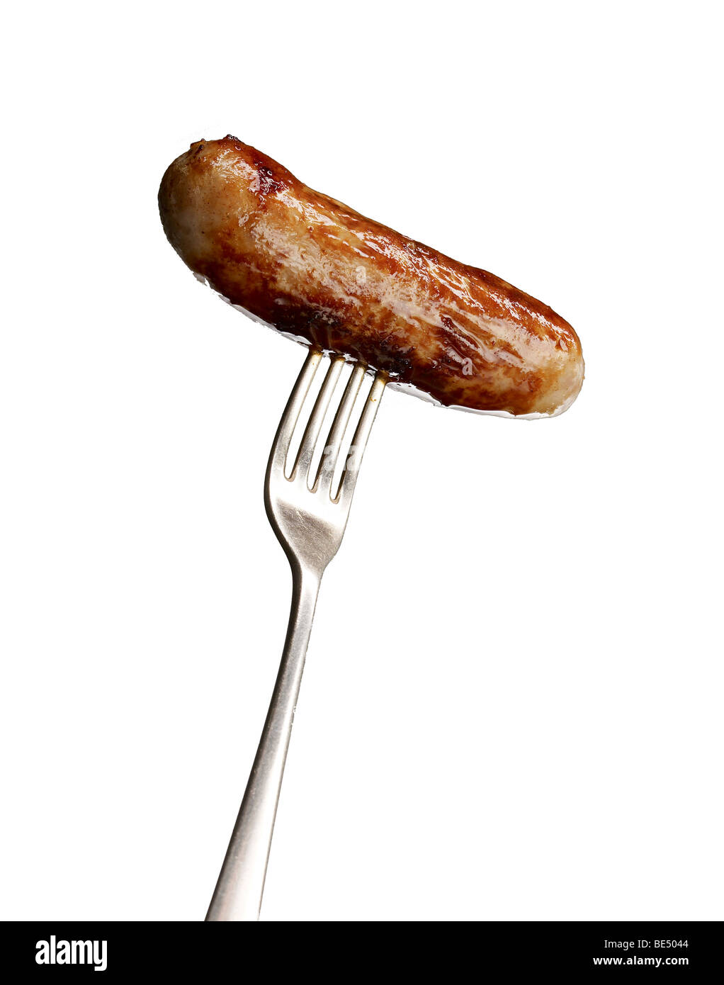 cooked sausage on fork banger snag Stock Photo