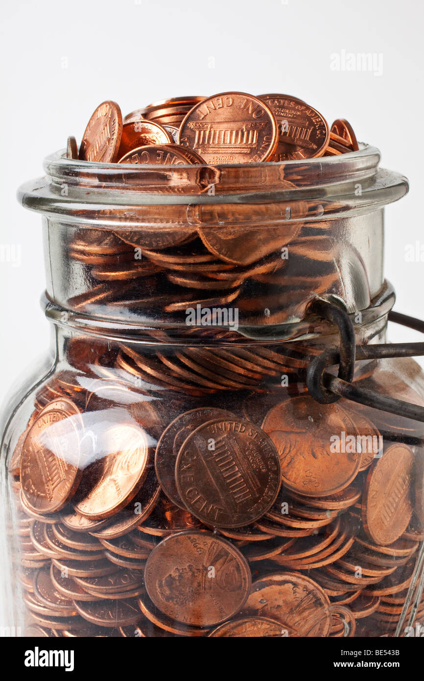 Glass jar of pennies Stock Photo