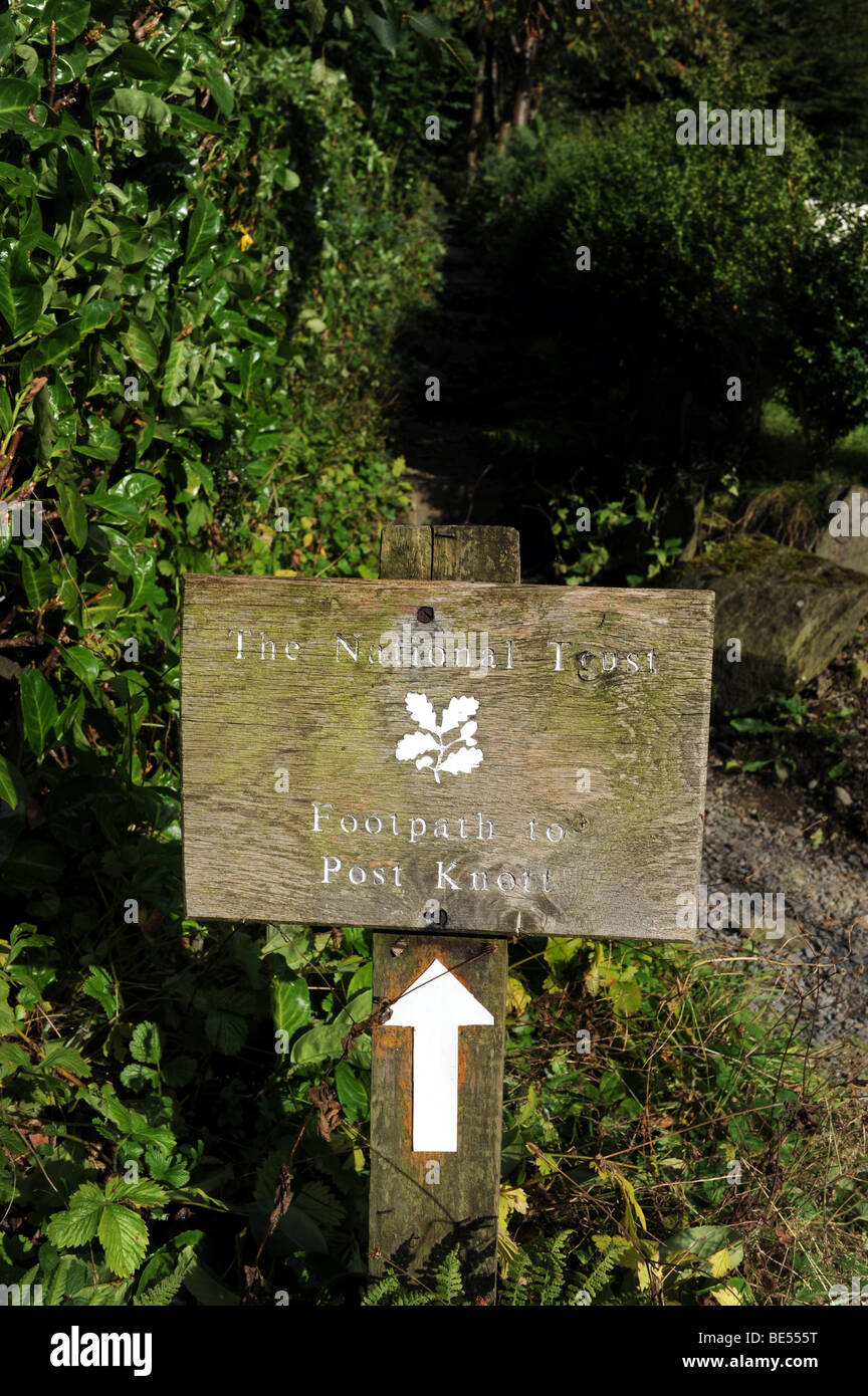Old wooden National Trust sign to Post Knott near Bowness and Lake Windemere in The Lake District in Cumbria UK Stock Photo