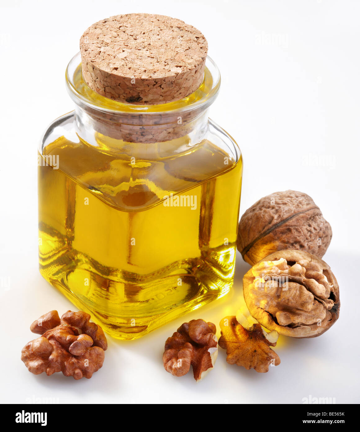Walnut oil with nuts on a white background Stock Photo