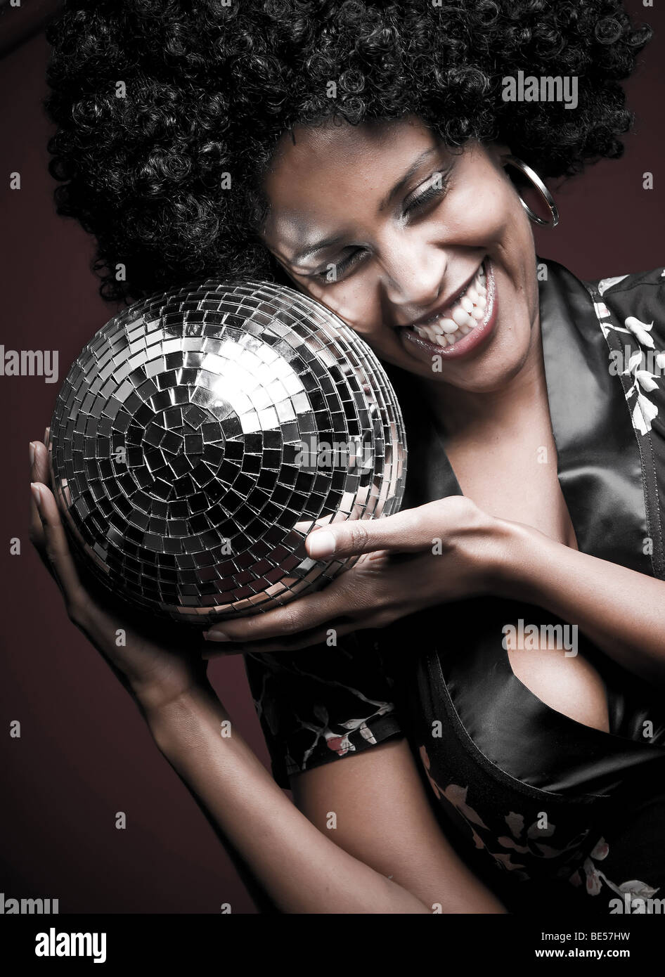 70s disco girl with a disco ball and a big afro hair Stock Photo - Alamy
